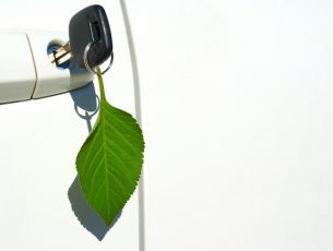 Environmentally friendly automobile with leaf key ring hanging from door.